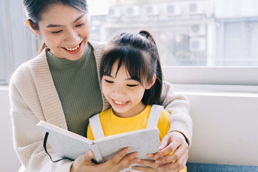 Mother and daugther practising chinese oral